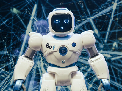 A sleek white and blue robot figure symbolizes advanced artificial intelligence in a modern environment
