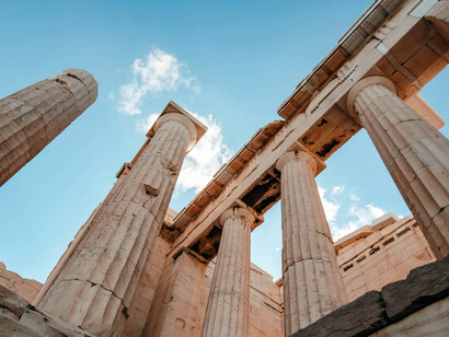 Sunlit columns of the Parthenon standing among ancient city ruins, Athens, Greece