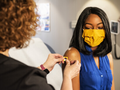 A girl receives the flu vaccine shot