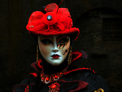 A woman in a red mask; the author is tired of facades and wants to feel something genuine