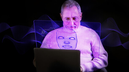 A person wearing a futuristic metaverse avatar mask, interacting with a computer