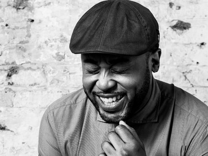 Tony Momrelle, 2016. Asset Downloads. TM Press Shot 10 b&w laughing