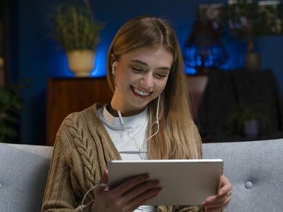 A viewer enjoying content on a tablet, representing how viewer preferences help shape the future of streaming platforms