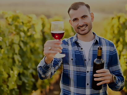 Capture the essence of Hungarian vineyards with a captivating portrait of a young, millennial vintner savoring the aroma of organic bio red wine amidst the lush vineyard scenery