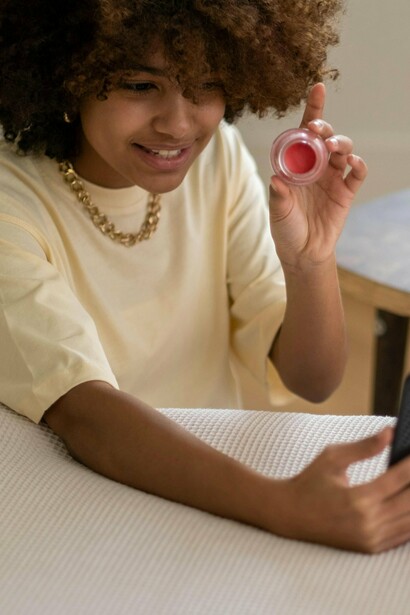 A woman showing her followers the product she's using and recommending