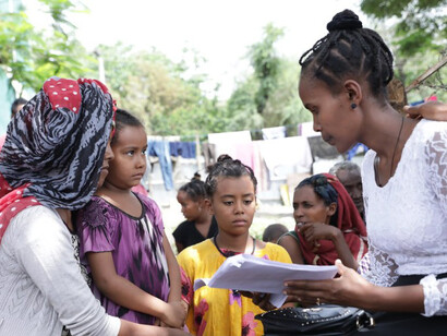 Social worker Meron Abeje supports Mulu Admassu, a mother of three who was displaced by conflict in the North Shewa Zone of Ethiopia’s Amhara region
