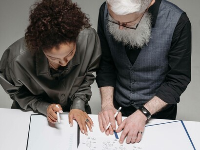 A duo viewing the data they assembled in their innovation poject