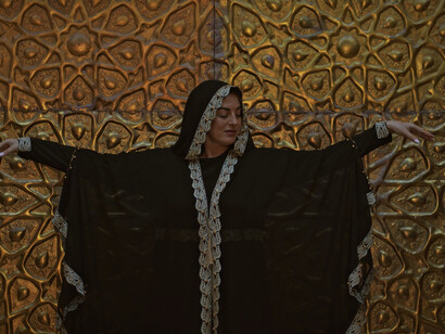 Bathed in golden light, she represents the quest for identity and self-discovery that permeates Mosteghanemi's works, inviting us to reflect on our own journeys