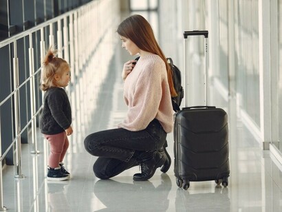 Mother and daughter at the airport with their luggage