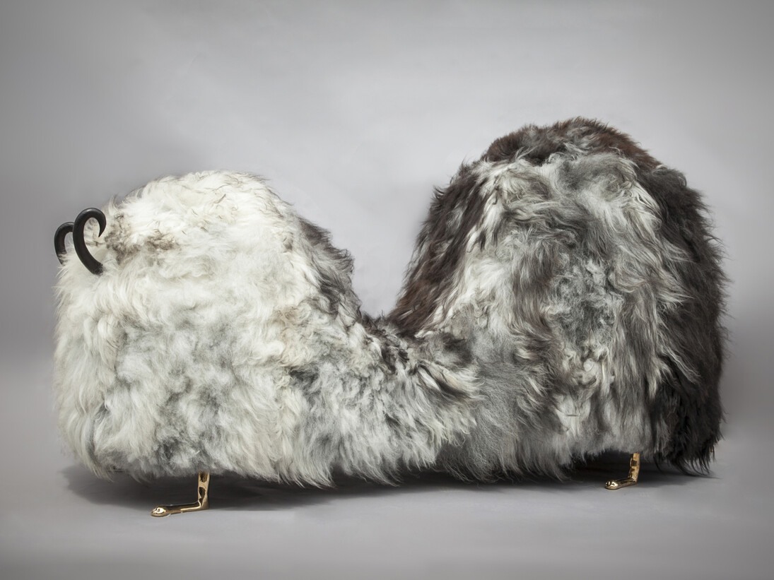Unique Hairy J. Blige double-hump bench from the Beast series, in Salt N' Peppa Icelandic sheep fur, with carved ebony horns, cast bronze lion feet, and cast bronze tits and a pussy. Designed and made by The Haas Brothers, Los Angeles, CA, 2014. 93" L x 38" W x 50" H / 236.2cm L x 96.5cm W x 127cm H. Photograph by Joe Kramm/R & Company
