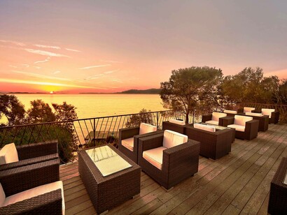 Visitors have the option of grabbing a refreshing drink as they gaze at the sublime sunset in Capo d'Orso, Sardinia