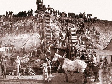 Miners and washing equipment at the Bultfontein Diamond Mine, Kimberley, South Africa. Woodburytype, 1888, after a photograph by Robert Harris