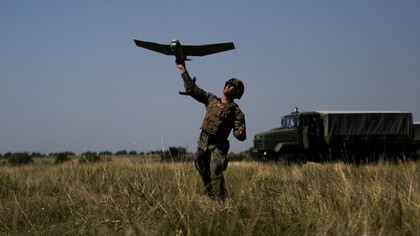 A U.S. Marine with Black Sea Rotational Force 17.1 launches an unmanned aerial vehicle during exercise Sea Breeze 2017 in Mykolayivka, Ukraine