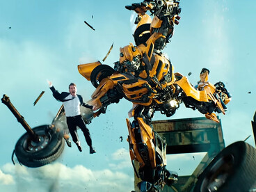 Bumblebee bursts through the chaos with Sam Witwicky airborne beside him, reflecting the controlled visual overload of Transformers: Dark of the Moon (2011)