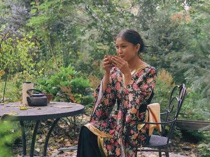 Surrounded by blooming flowers, she discovers that silence is not empty, it’s a space where her true self begins to emerge