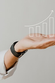 Digital bar graph with increasing trend and businessman’s hand overlay