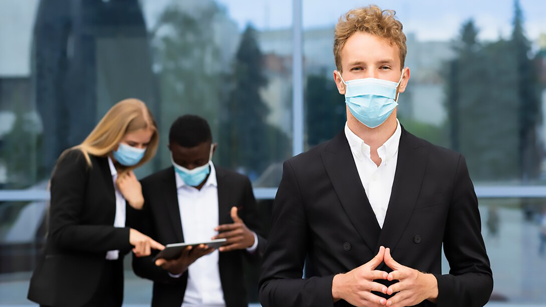 During the COVID-19 pandemic, individuals diligently wear masks while working for their safety