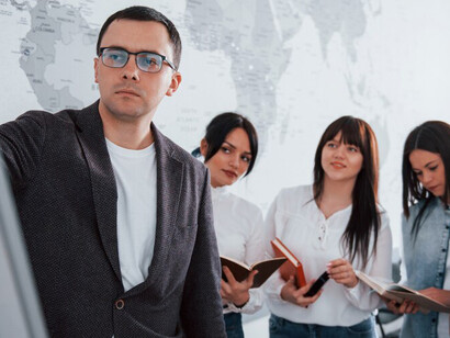 Managers and business professionals partnering on international development projects, focusing on sustainable development by fostering development cooperation across diverse stakeholders