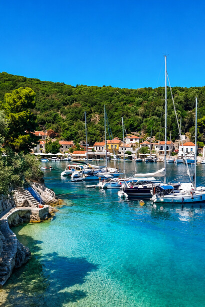 Overlooking Kioni Village on Ithaca Island, Greece, where turquoise waters, fishing boats, and traditional hillside houses create a postcard-perfect scene