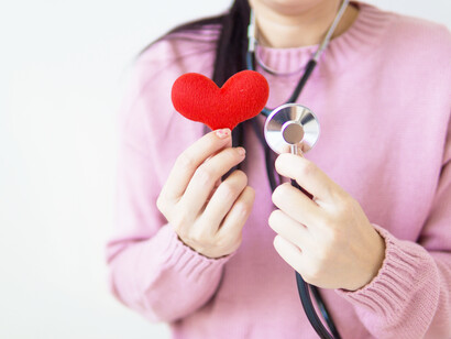 A woman, a heart and stethoscope