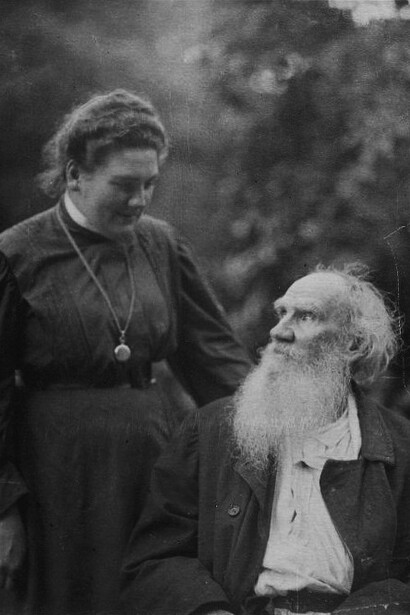 In 1908, Leo Tolstoy is sitting in the park, while Alexandra Tolstaya stands to his left