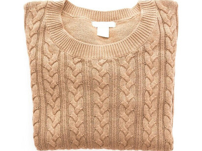 An Irish Aran sweater proudly on display, showcasing its intricate patterns and rich cultural heritage