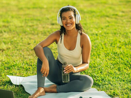 The serene outdoor setting enhances her connection to the body as a temple, using the rhythm of her motivational music to align mind, body, and spirit