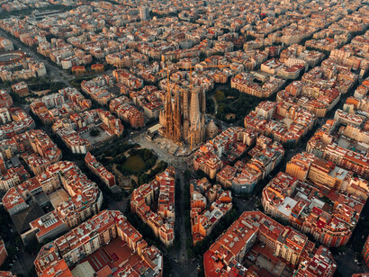 Aerial photography showcasing 
La Sagrada Familia, the intricate city infrastructures and the distinctive rooftops of Barcelona