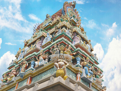 Colorful Dravidian temple gopuram rising against the blue sky in Chennai, India