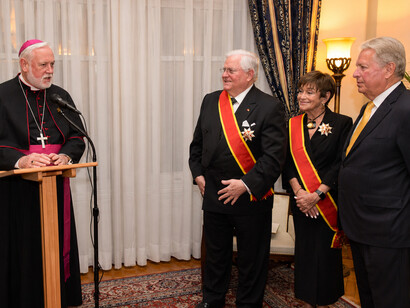 Vatican foreign minister Archbishop Paul Richard Gallagher bestowing the honor of Grand Cross on Gary and Meredith Krupp October 2, 2018 in New York. Chairman of PTWF Elliot Hershberg is by their side