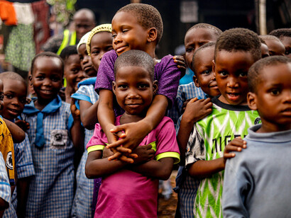 A group of African children pose for a photo, reflecting the realities of poverty and malnutrition
