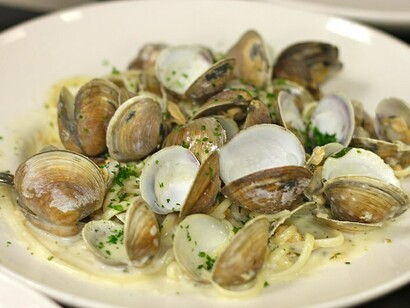 Linguini and clams with fresh herbs, white wine, and tender little neck clams, served family-style, celebrating the Feast of the Seven Fishes