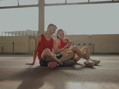 A couple checking out their selfie before they resume their workout