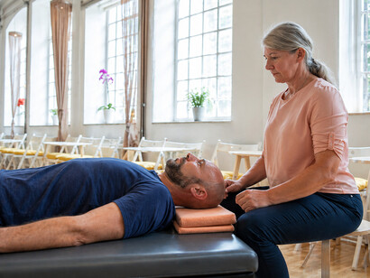 A senior practitioner leading a therapeutic movement session focused on embodiment, nervous system awareness, and holistic mind-body healing through the Feldenkrais Method