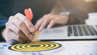 Business strategy success targets and goals illustrated on a dartboard