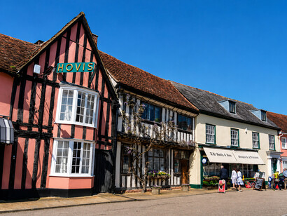 Lavenham is a picturesque village and civil parish in Suffolk, England, renowned for its medieval Guildhall, Little Hall, 15th-century church, half-timbered houses, and scenic walking trails. During the Middle Ages, it ranked among the twenty wealthiest settlements in England