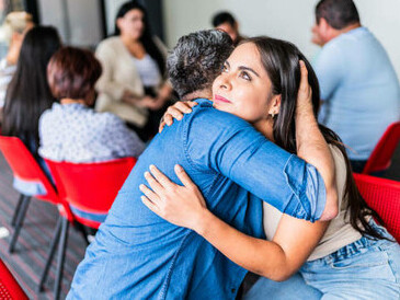 People embracing during a session, symbolizing societal harmony and mutual respect