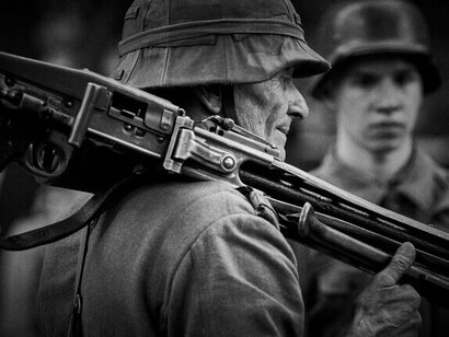 Soldiers gathered in a moment of calm during war, illustrating the generation lost to conflict and misjudgment