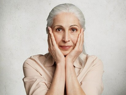 An elderly woman poses confidently, embodying the essence of aging gracefully and embracing a healthy, vibrant lifestyle
