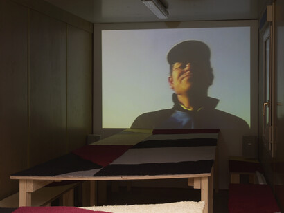Erik van Lieshout, Rotterdam – Rostock, 2006, 
DV transferred to DVD (17 minutes),  Shipping container, wood, carpet Courtesy the artist and Maureen Paley
