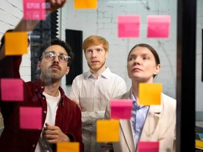 Colleagues are reviewing posts and using tools such as a decision tree diagram, cost-benefit analysis, SWOT analysis, and data analytics to make informed decisions