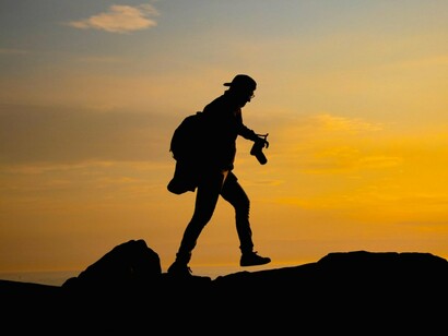 A person moving ahead through challenging terrain, representing resilience in the face of life's obstacles