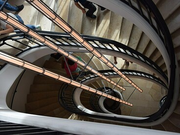 The Bourse de Commerce’s distinctive double-helix staircase, originally designed to separate ascending and descending workers, Paris, France