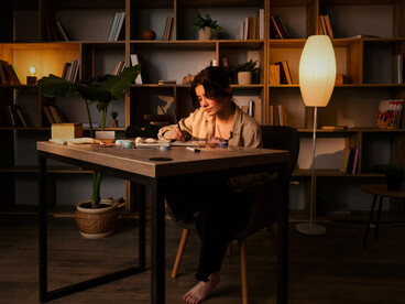 A woman focussed on craftsmanship within a dimly lit room, reflecting the unseen devotion behind meaningful art