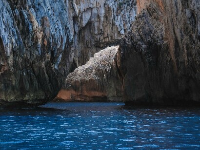 A sea cave carved into rugged volcanic rock, reflecting the island’s geological history and natural coastal beauty