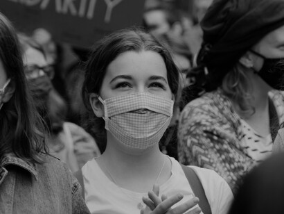 Young woman during a protest. Rejection of women’s rights, lesbian and gay rights, human rights are no longer the purview of the God of the right, but are in equivalent jeopardy from the ideas of the left treated as gods
