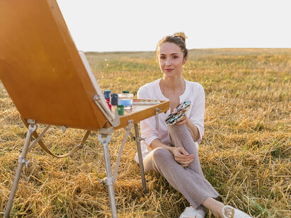 An artist mixing vibrant paints on a canvas, illustrating the cultural significance of colour in abstract art