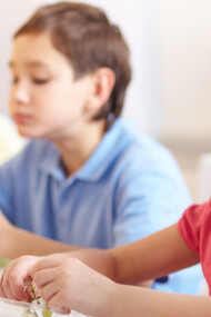 Smiling girl enjoying grapes as part of a healthy school lunch