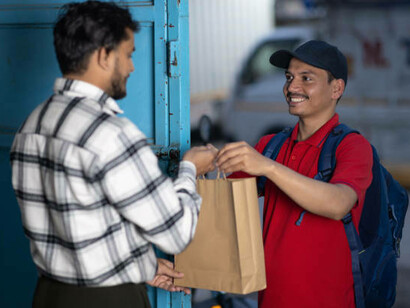 A food delivery worker in India on his way to deliver an order, reflecting the growing demand for convenience in modern urban life, India