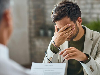 A happy male candidate greeting a member of the human resources team during a job interview in the office, representing the interaction between the employer and the candidate